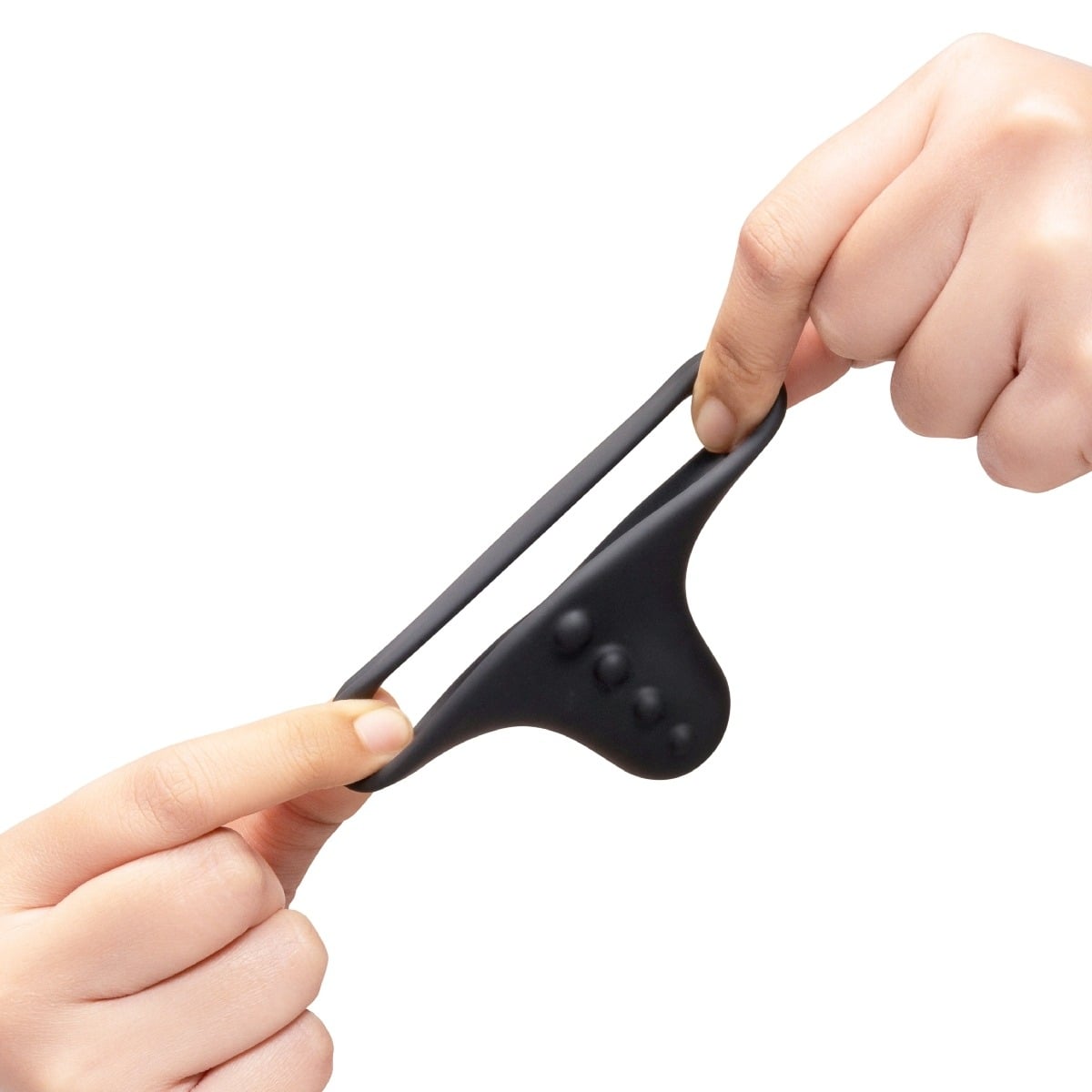 Hands pulling b-Vibe FLEX RING SHAFT - SILICONE COCK RING & BALL STRETCHER to show elasticity