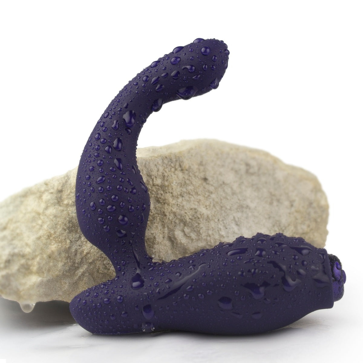 Rocks Off Sovereign Rechargeable Prostate Massager next to a rock with water drops