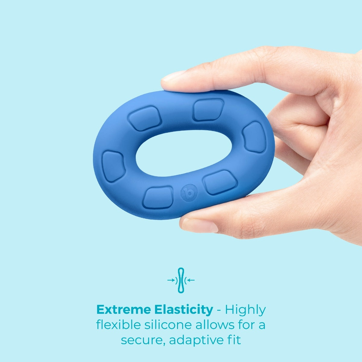 Hand squeezing b-Vibe Flex Ring Ultra-Soft Silicone Cock Ring – Blue showing extreme elasiticity