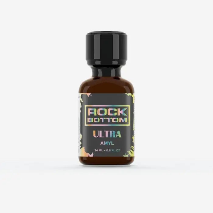 A small amber glass bottle with a black cap and a black label reading 'ROCK BOTTOM ULTRA AMYL 24ml' poppers on a light grey background.