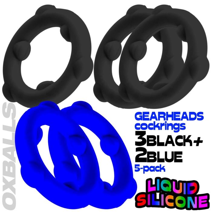 Five black and two blue Oxballs gear-shaped cock rings with product packaging text on a white background.