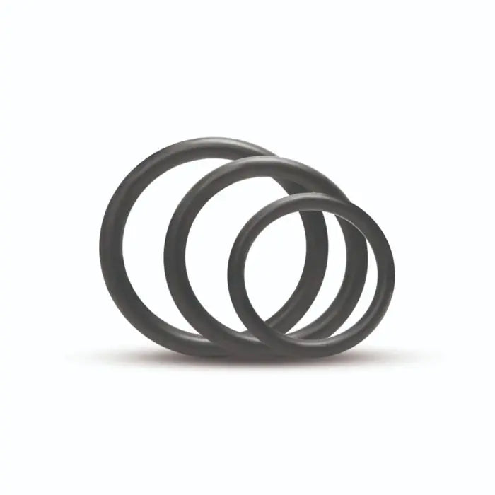 Three black rubber o-rings stacked on a white background that come with the Me You Us Pegging Harness Kit